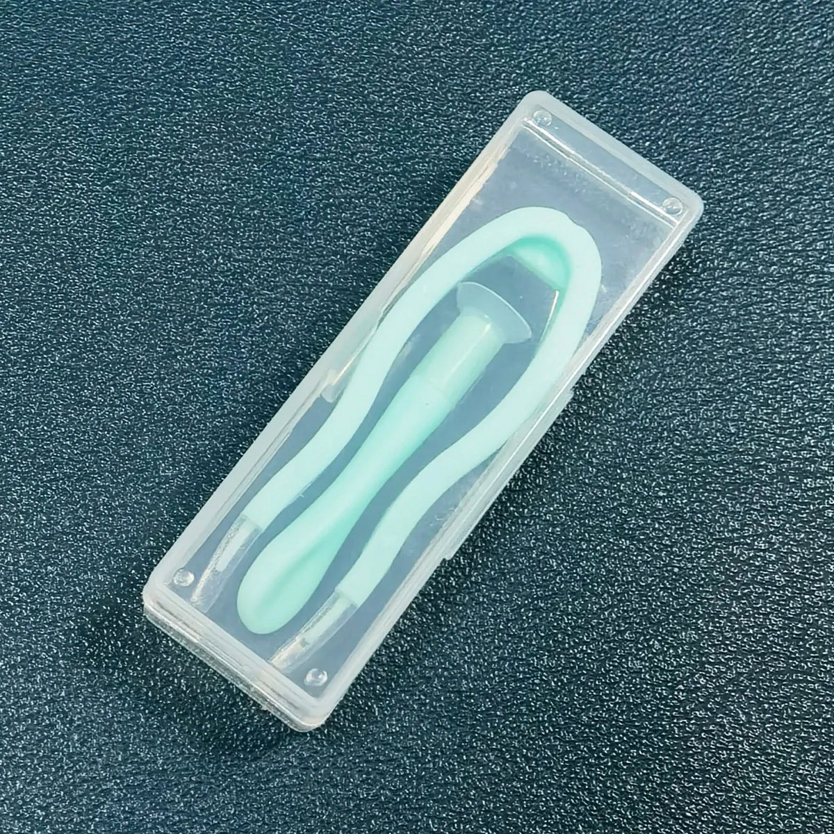 A clear plastic case containing a 5-piece portable contact lens tool kit with a light green instrument inside.