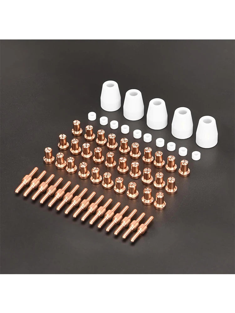 A collection of plasma cutter consumables including nozzles and tips arranged on a dark surface.