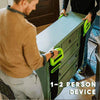 A person is using a green heavy-duty furniture moving strap with a handle to move a cabinet.