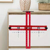 A red adjustable cabinet handle punch locator guide tool with a cross shape and measurement markings.