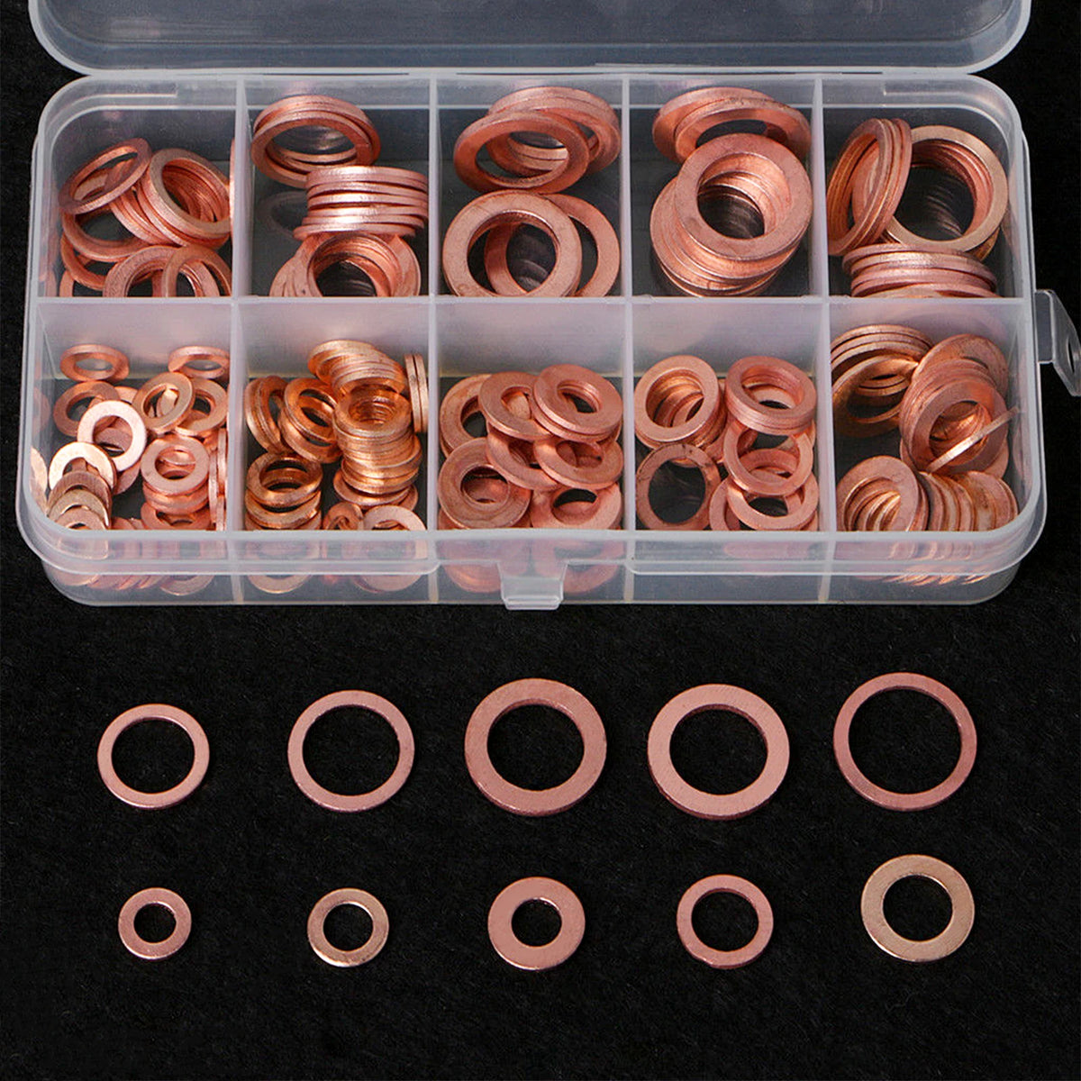 A clear plastic box filled with precision copper gaskets and washers, arranged in compartments.