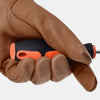 A hand wearing brown leather gardening pruning gloves is holding a black and orange tool.