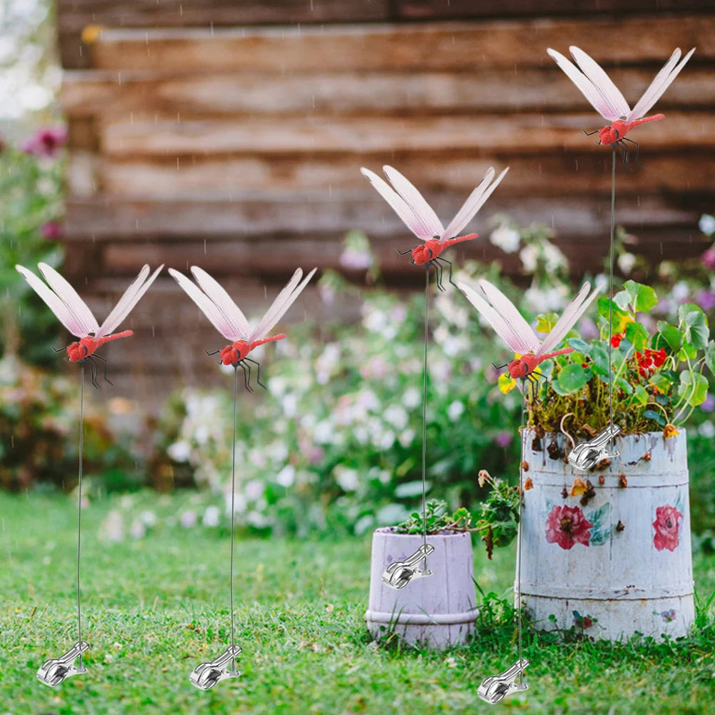 Realistic dragonfly clips are displayed on grass with various flowers and a weathered galvanized bucket.