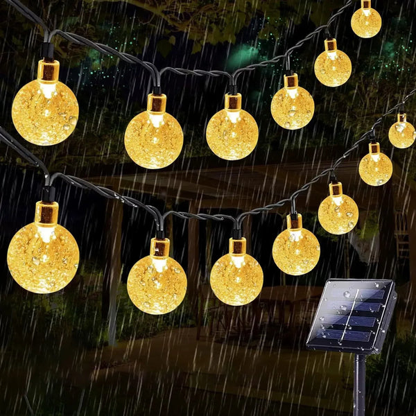 String lights with yellow globe bulbs are strung across a dark background, simulating rain.