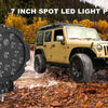 A yellow Jeep is driving through water, with a 7 inch spot LED light pod mounted on the front.