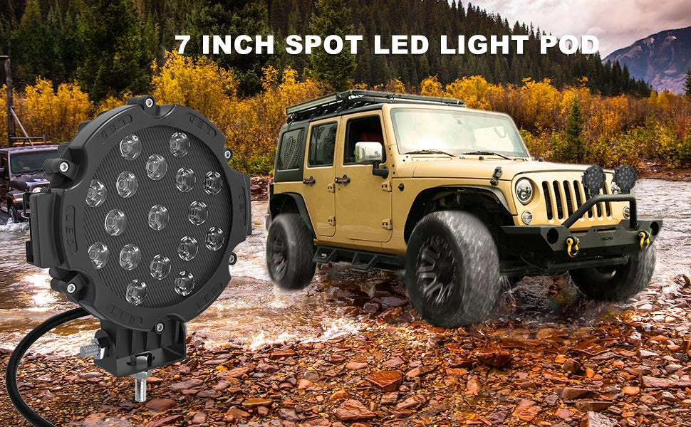 A yellow Jeep is driving through water, with a 7 inch spot LED light pod mounted on the front.