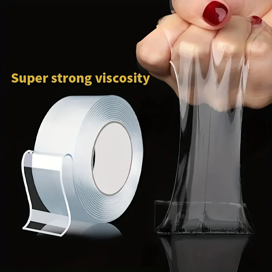 A hand is applying a roll of clear, viscous mounting tape to a surface, demonstrating its super strong viscosity.