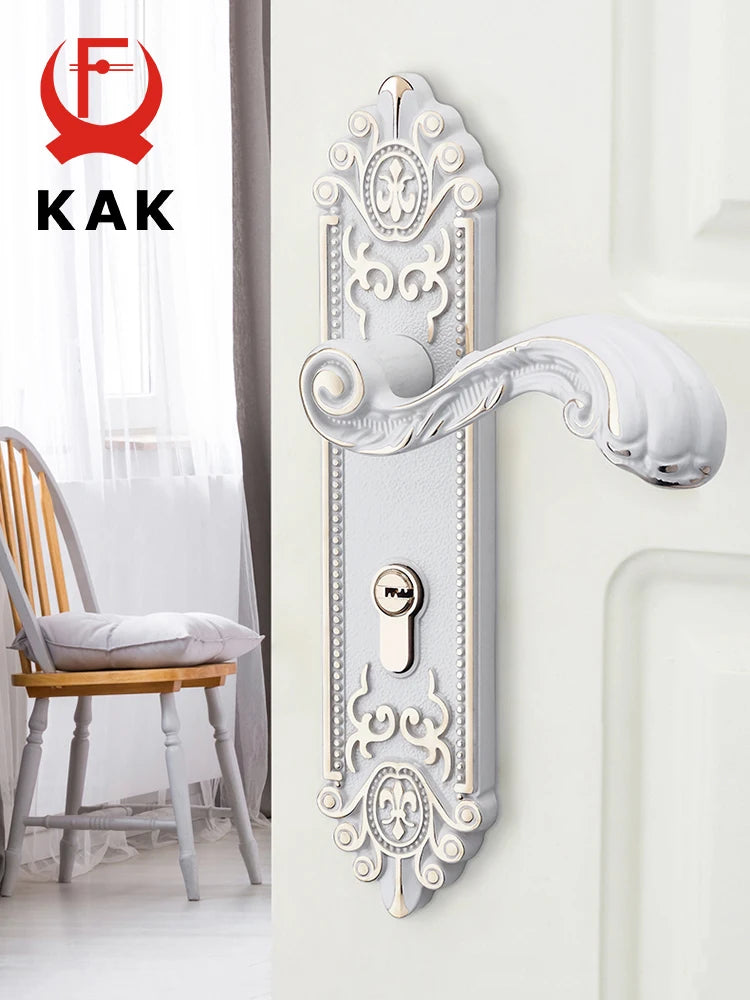 A decorative European style gold door lock with keys mounted on a white wall.