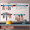 A heavy duty magnetic tool rack organizer displaying various hand tools and hardware on a white board.