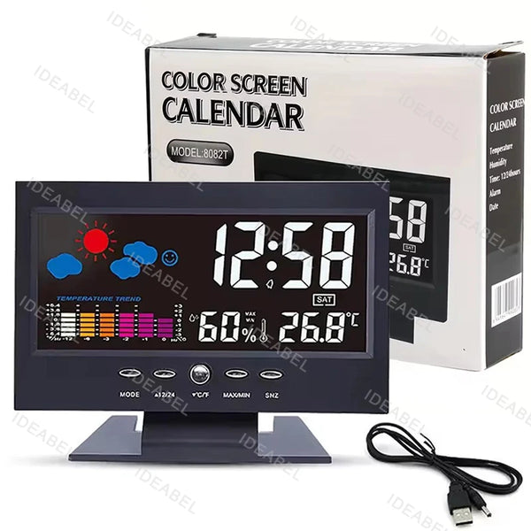 A digital weather station clock with a display showing 12:58 and temperature 26.8 degrees, next to its box.