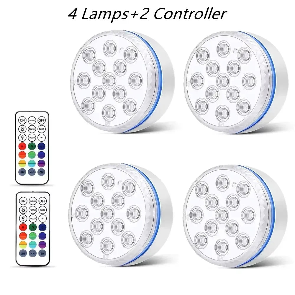 Quatre lumières LED submersibles pour piscine et deux télécommandes pour éclairage sous-marin.