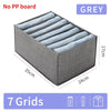 Grey fabric storage organizer box with seven grid compartments shown from above.