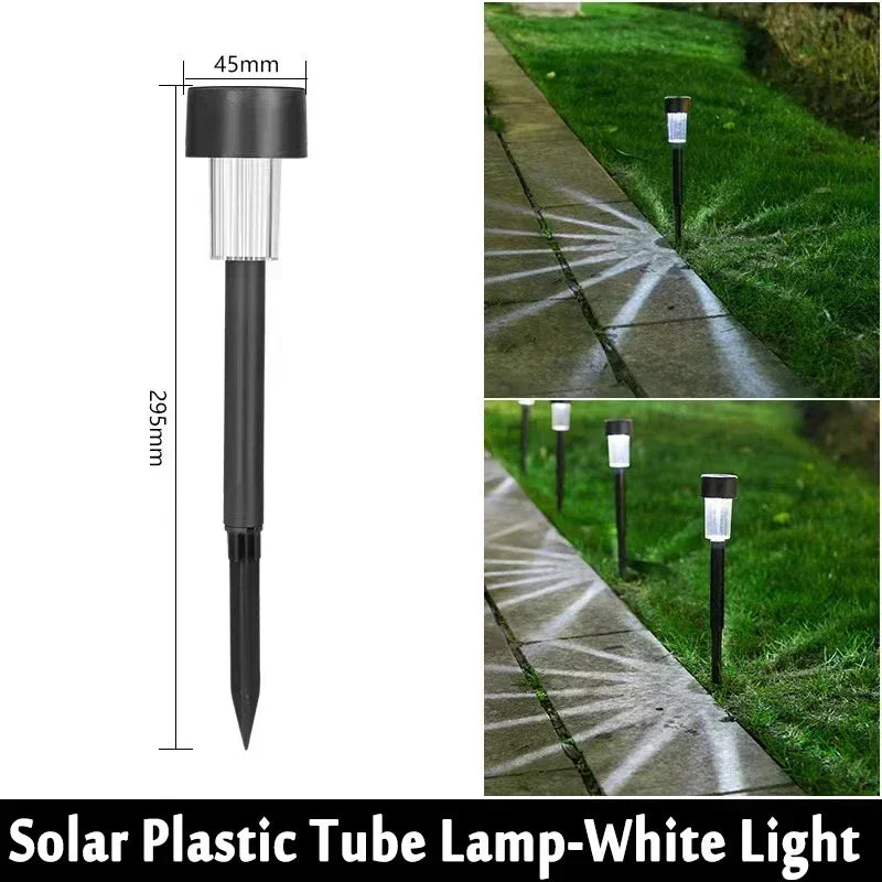 A black solar plastic tube lamp mounted on a stake, illuminating a pathway with white light.