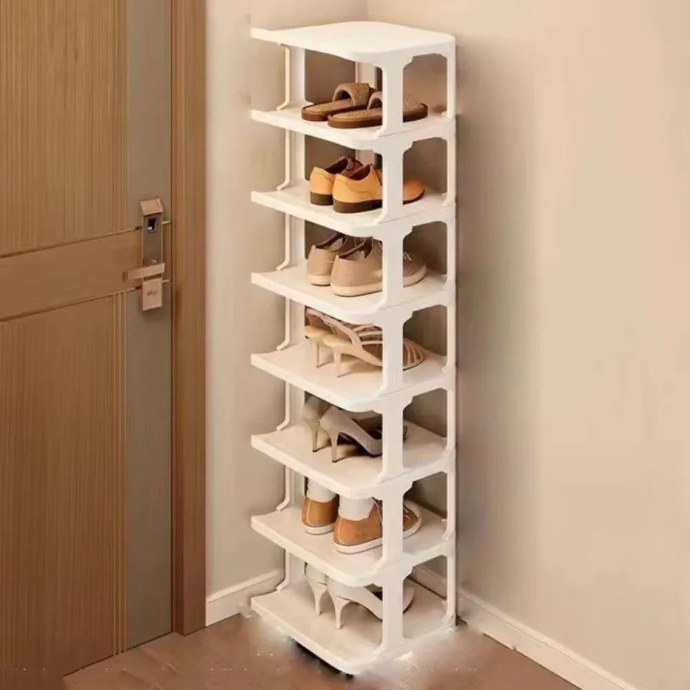 A white stackable vertical shoe rack organizer with multiple tiers holding various pairs of shoes.