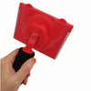 A hand is holding a red paint edge trimmer and corner brush set, showing the tool's head.