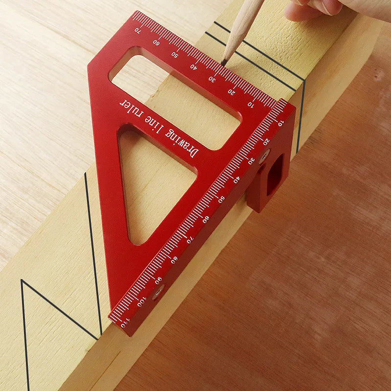A red aluminum miter triangle layout tool is shown measuring a piece of light yellow wood.