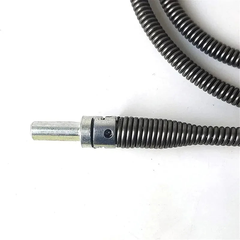 A silver spring-loaded drain cleaning tool with a drill adapter and a coiled black wire.