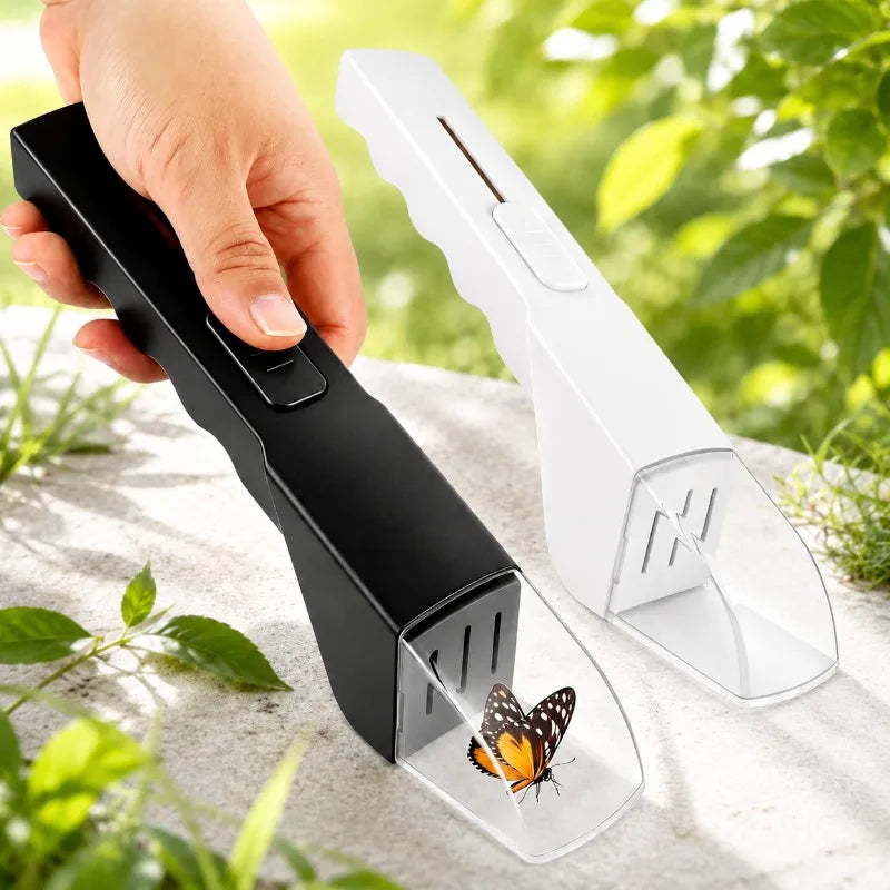 A hand holds a black handheld insect trap with a butterfly silhouette, next to the white trap body.