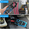 A hand holds a blue digital clamp meter measuring AC current near electrical wiring.