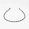 Black metal elastic headband with a twisted design for wavy hair