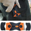 A dual-purpose razor scraper tool shown in black and orange, with a hand wearing a light glove holding the product.