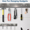 A collection of various tools and gadgets are displayed hanging on metal magnetic strips.