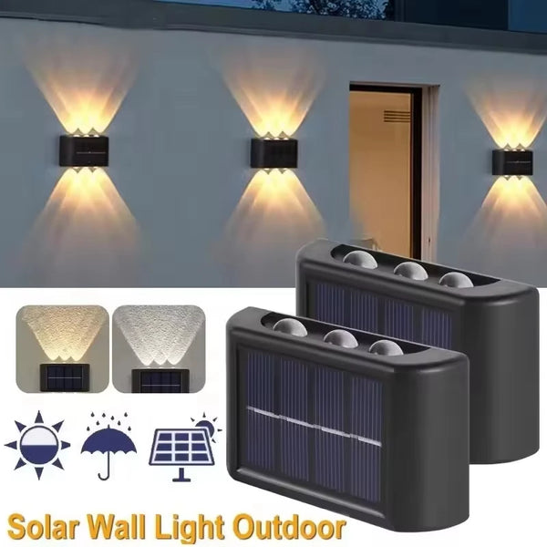Outdoor solar wall light fixtures illuminating a wall, featuring multiple light heads and solar panels.