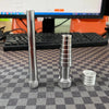 A silver professional ring stretcher and expander tool is shown on a checkered surface.