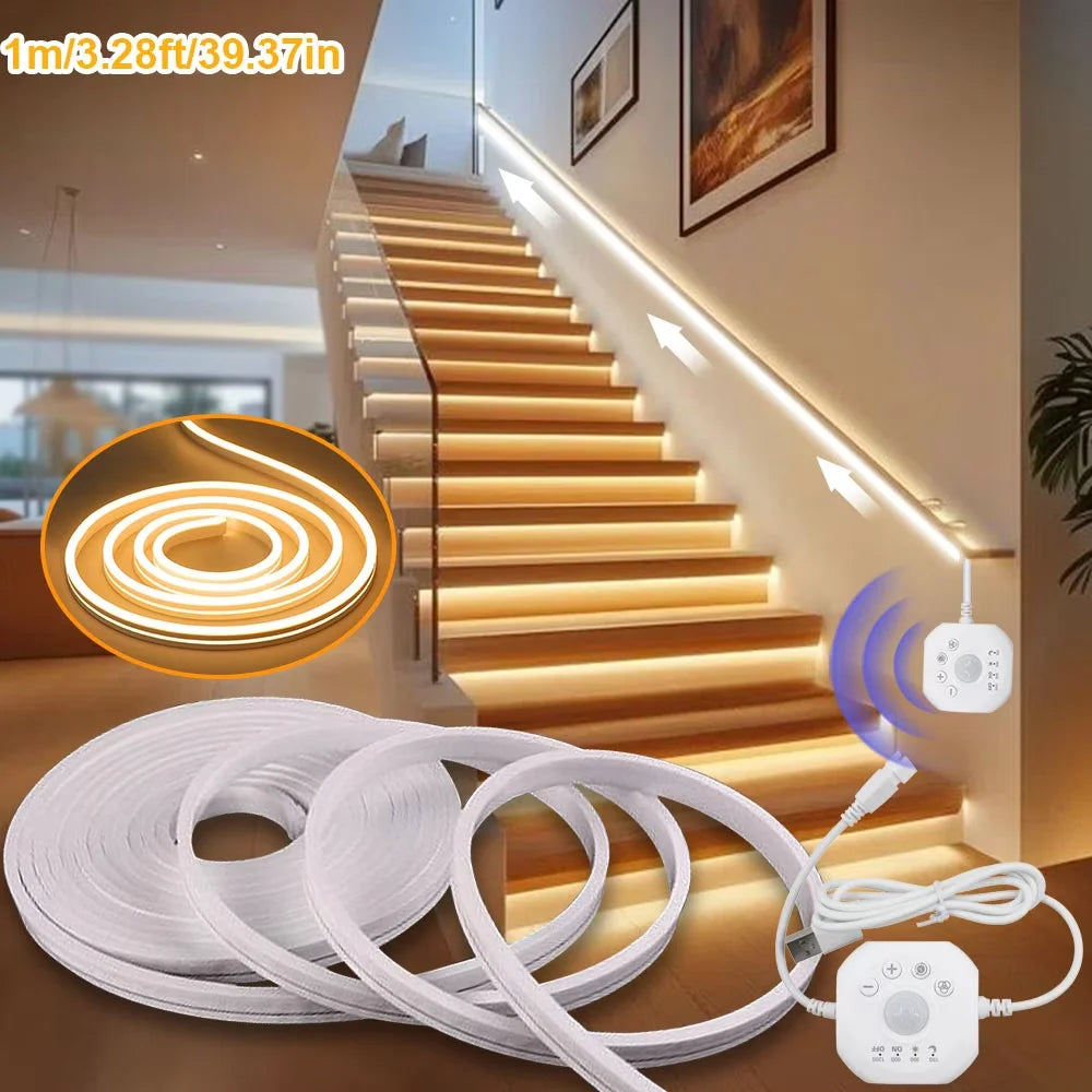 White LED motion sensor light strip with chasing neon effect illuminating a wooden staircase.
