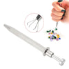 A silver precision diamond gripper tool is shown next to a hand holding small, colorful gemstones.