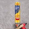 A yellow and black foam glue expanding spray gun is shown against a gray background.