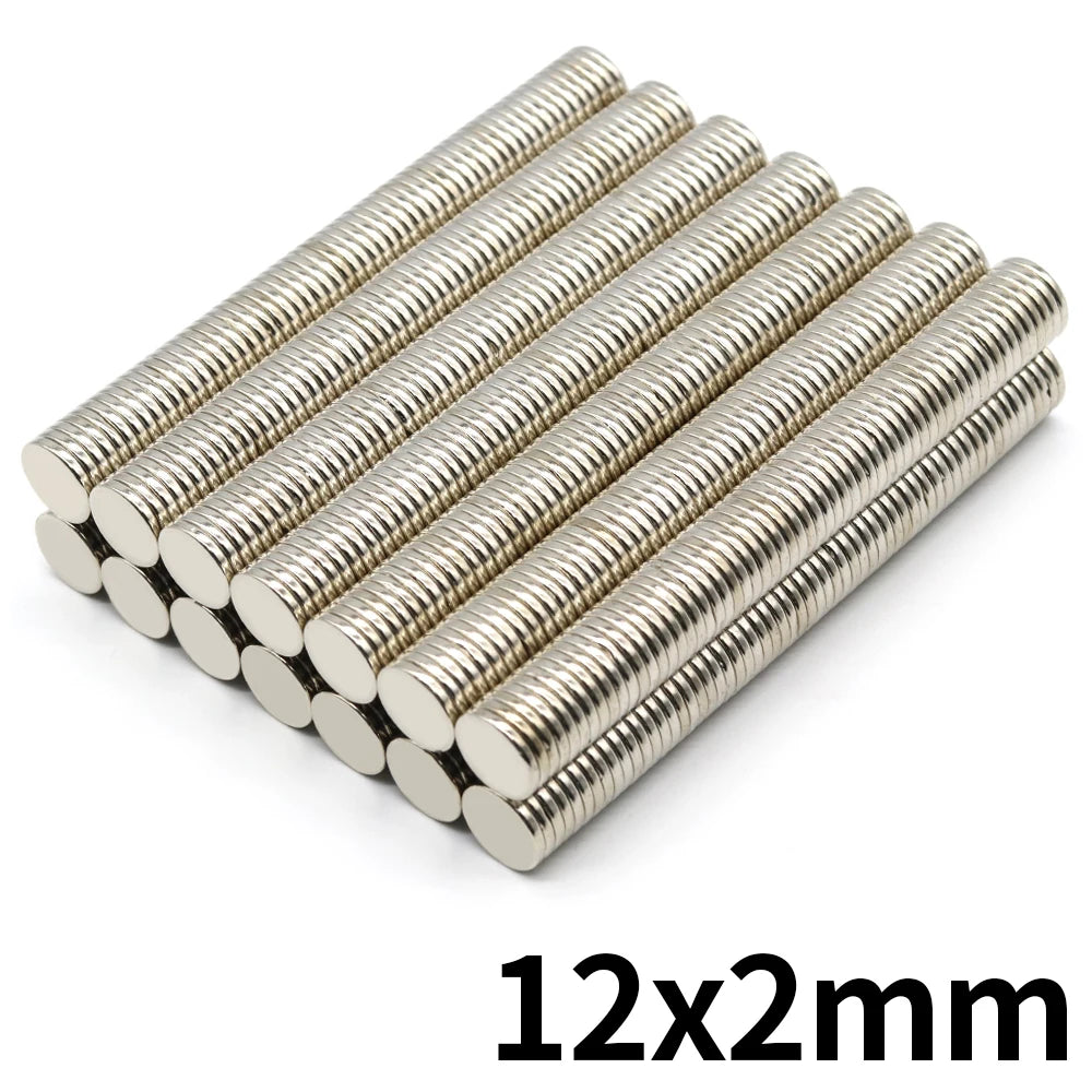 A close-up view of a set of silver refrigerator magnets with 12x2mm thickness.