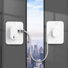 A white universal door and window safety lock with a cord is mounted on a gray door frame.