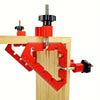 Red L-shaped angle splicing fixture mounted on a wooden block for woodworking
