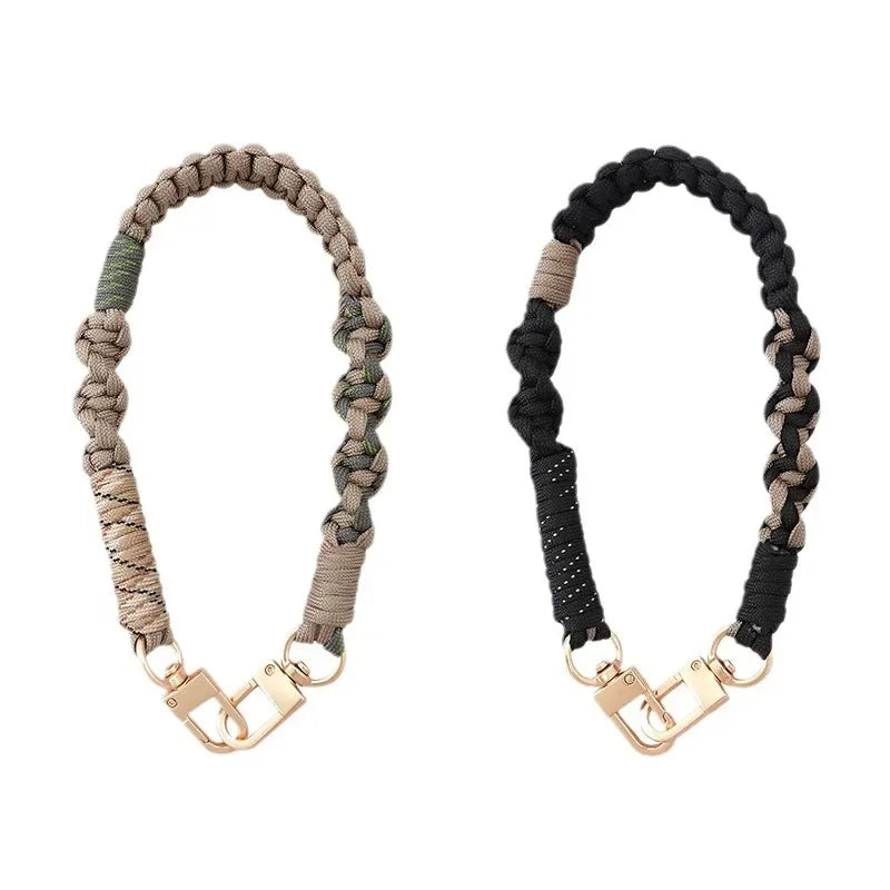 A pair of hand-braided phone lanyards, one in beige and one in black.