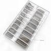 A clear plastic tray containing numerous stainless steel watch repair pins and spring bars.