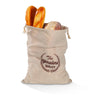 A beige linen drawstring bag filled with two bread rolls and a round loaf of bread.