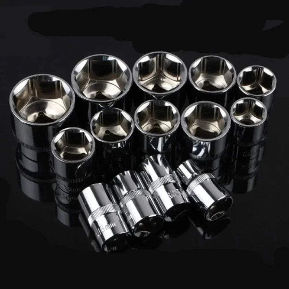 A set of twelve shiny metal wrenches and sockets arranged in a row on a dark surface.