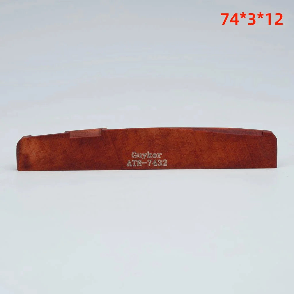 A wooden acoustic guitar bone bridge saddle with the model number Guyzer ATR-7432.
