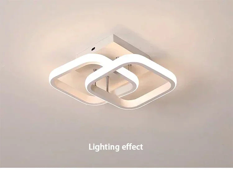 Lámpara de techo LED moderna con diseño ovalado blanco y cruzado, montada en la pared.