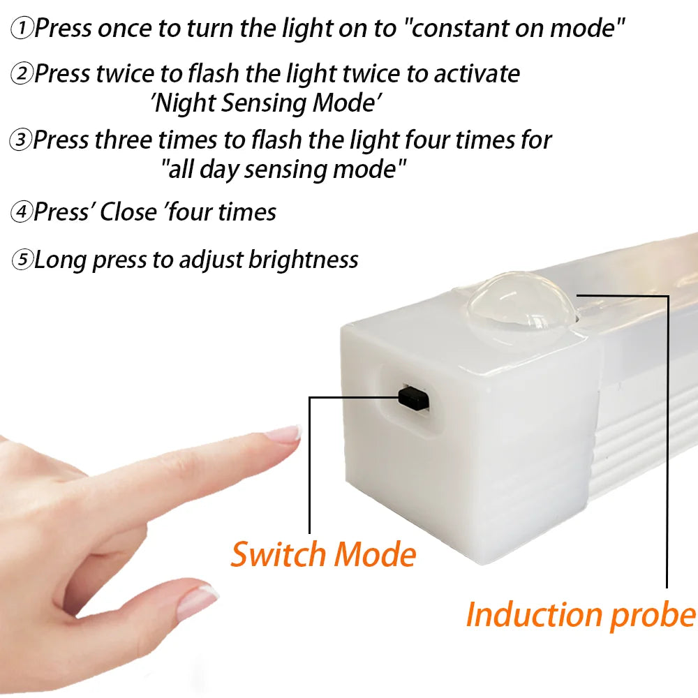 A hand is shown pressing a switch on a white LED motion sensor night light to change its mode.
