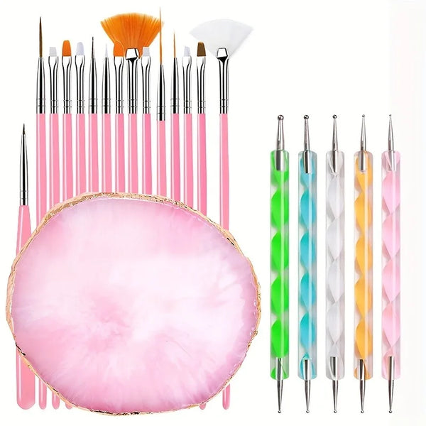A set of professional nail art brushes in various colors including pink, orange, and white, displayed on a pink acrylic surfa