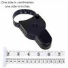Black portable telescopic health tape measure with a torch and ruler markings.