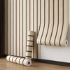 Roll of self-adhesive wood grain wall panels in light beige and brown stripes mounted on a white wall.