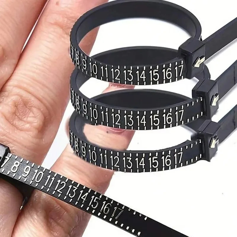 A hand holds a black accurate finger ring sizer with multiple rings for measuring fingers.