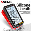 A black digital multimeter with a red casing and silicone sheath is shown on a textured surface.