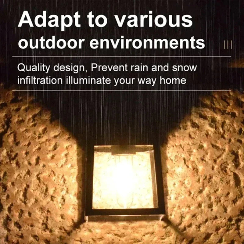 A solar motion sensor outdoor wall light illuminates a textured stone surface.
