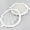 Two white reusable mesh strainers for bathroom drains, shown from above.