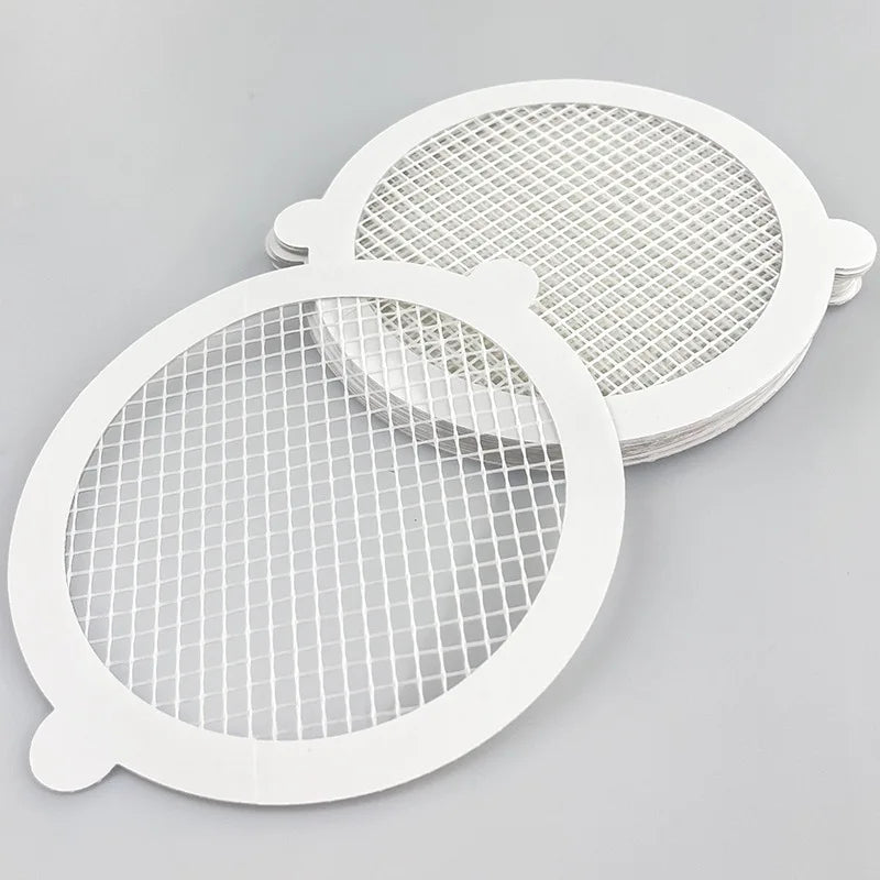 Two white reusable mesh strainers for bathroom drains, shown from above.