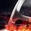 Close-up of a forged geological rock pick hammer with a reddish-brown finish, showing sparks and intense heat.